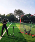 Man using 7x7 Baseball Practice Net With Sturdy Steel Frame For Batting Hitting And Pitching Portable Softball Net outdoors