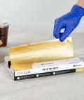 Gold Embossed Pop-Up Foil Sheets 10.8 X 9 Inch being extracted from box, ideal for fast service kitchens, keeps food warm on the go.