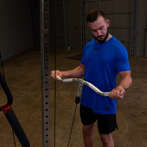 Man using Straight Up Heavy Duty Aluminum Curl Bar Attachment Compatible With Cable Machines in home gym.
