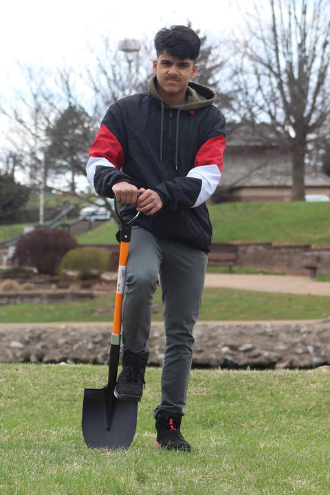 Person holding Heavy Duty Digging Shovel 41 Inch With Trenching Blade And Comfortable Handle For Garden Landscaping Construction And Masonry