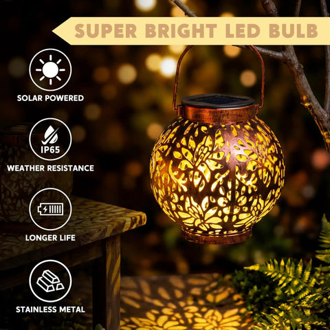 Two Pack Outdoor Solar Hanging Lantern Lights With Handle Waterproof Tabletop LED Moroccan Style Metal Garden Lanterns For Patio Lawn Porch Backyard Dope Lighting glowing in garden setting with leaf cutout design
