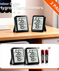 Two Pack Indoor Thermometer And Humidity Monitor With Digital Temp And Humidity Gauge, Real Time Readouts, Battery Included, Ideal For Home, Baby Nursery, Reptile Enclosures, And Greenhouses. Two black digital hygrometers on desk with AAA batteries
