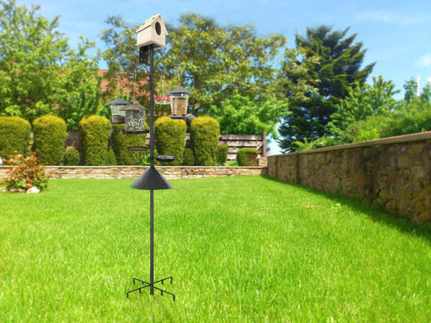 Squirrel Proof Bird Feeder Pole Kit, 92 Inch Height With 9 Prongs Base, positioned in a garden with bird feeders and birdhouse on top.