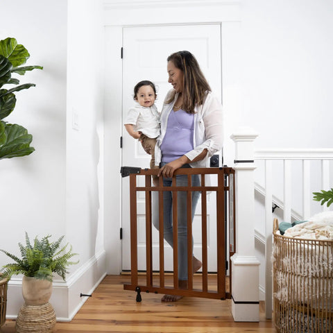 Wood Banister And Stair Safety Gate For Babies And Pets, Adjustable 32 To 48 Inches Wide, 33 Inches Tall, Oak Finish in doorway