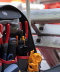 ToolPack Pro Backpack For Roofers, Electricians, Data Techs, Glaziers, And Handymen The All In One Heavy Duty Tool Bag Backpack With Ample Pockets Easy Access Durable Build And Comfortable Straps Ready For Any Job Site filled with tools and positioned by ladder