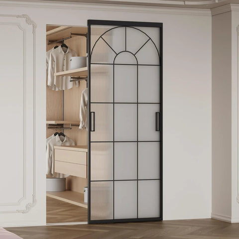 Hardcore Interior Sliding Barn Door Featuring Textured Reeded Glass Panels And Matte Black Frame Hidden Wall Track Kit Saves Wall Space And Moves Like Butter In Any Room Setup, showcased in a modern closet.