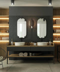 Modern bathroom design featuring two sinks, mirrors, and wood shelves for storage and decor.