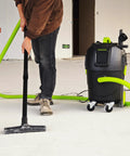 Person using 8 Gallon Dust Extractor With Auto HEPA Clean And Remote Control For Woodworking 150 CFM Airflow on workshop floor