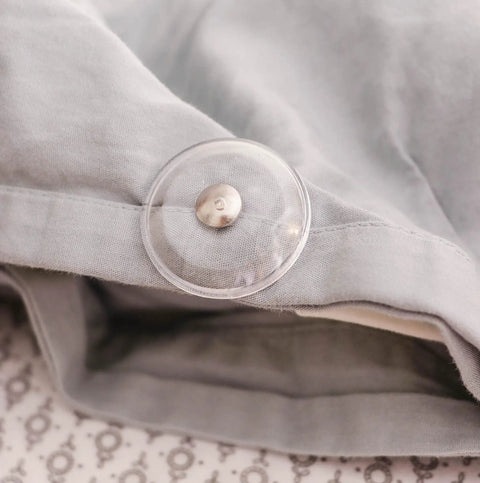 Close-up of a Clear Magnetic Duvet Clips With Magnetic Key For Easy Removal Pack Of 8 Safe Locking Comforter Fasteners on fabric