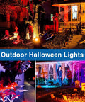 Halloween display with All In One RGBW Low Voltage Landscape Lighting Kit With Transformer and Timer illuminating garden and trees