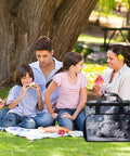 Family enjoying picnic with Go-To Insulated Picnic Backpack Tote With 30L Capacity, snowman stars snowflakes design visible.