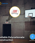 Clear Polycarbonate Emergency Exit Sign Cage Guard protecting lighted sign in gym, mounted on wall, impact resistant.