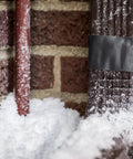 Ferociously Strong Duct Tape One Point Eight Eight Inch By Thirty Five Yard Dark Gunmetal Gray on snowy brick and pipe