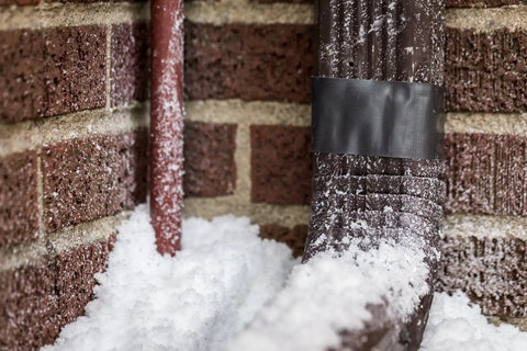 Ferociously Strong Duct Tape One Point Eight Eight Inch By Thirty Five Yard Dark Gunmetal Gray on snowy brick and pipe