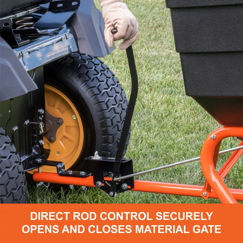 Close-up of tow behind lawn and garden broadcast spreader with 185 lb capacity, showing control rod and material gate mechanism.