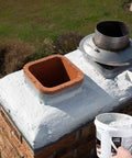Applying Bone Dry Chimney Crown Sealer Brushable Elastomeric Waterproof Membrane on chimney crown with a brush.