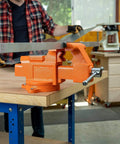 Heavy-Duty 6-Inch Bench Vise With Swivel Base, 6 Inch Jaw Opening, 3 Inch Throat, displayed on a wooden workshop bench