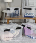 Built To Last Clear Storage Bins 54 Quart 2 Pack, Stackable Plastic Totes With Tight Lids, Gasket Sealed Waterproof Containers on a table.