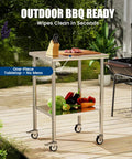 Stainless Steel Rolling Work Table With Wheels 24x24 Inch NSF Certified Pro Grade Heavy Duty featuring undershelf and accessories in outdoor setting.