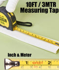 10FT 3MTR measuring tape with black and yellow casing, showing measurements in inches and meters on a green background.