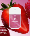 Berry Bliss spray bottle in front of fresh strawberries, part of Hydrating Hand Sanitizer Spray Trio Set With Aloe Vera And Essential Oils
