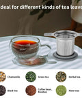 Stainless Steel Loose Leaf Tea Infuser With Extra Fine Mesh Ball Heat Proof Dual Handle Steeper next to a glass cup of tea