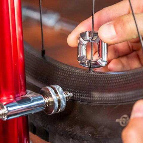 Using 4 In 1 Bicycle Spoke Wrench Kit With 3 Spoke Nipples Tools Plus Valve Core Remover And Valve Extender Holder on bike wheel.
