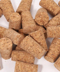 25 Pack Natural Soft Wood Corks, Tapered Bottle Stoppers for Wine Making and DIY Crafts, shown in scattered arrangement