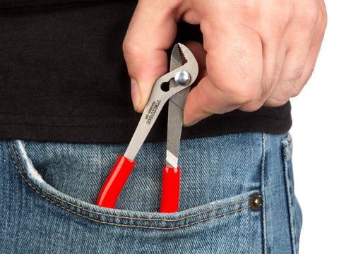 Five Inch Angle Nose Slip Joint Pliers With Half Inch Jaw being placed in jeans pocket, red slim non slip grips visible