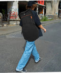Dang Tough Dumb Drum Carrying Case Stitched From Heavy Gauge Waterproof Oxford Material To Store Percussion Equipment Safely And Keep Things Slick While You Cruise Down The Interstate In Solid Black, worn on back.