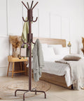 Standing Coat And Hat Rack With 12 Hooks Bronze Finish, Space Saving Organizer For Coats, Hats, Scarves, And Bags, in a bedroom