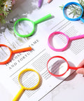 Colorful 48 Pack 5 Inch Kids Magnifying Glass Set, 5X Hand Lenses on a book, Durable Acrylic Frame