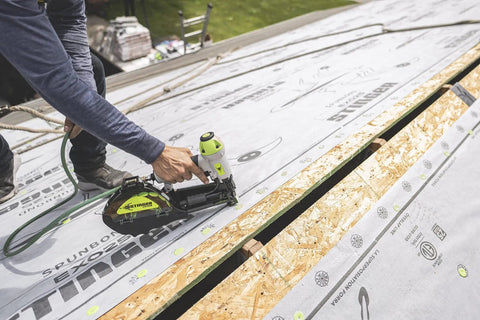 Solid Grip 1 Inch Plastic Cap Staples 2000 Ct Spool being used with pneumatic stapler on housewrap installation.