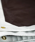 Close-up of Ultra Heavy Duty Waterproof Tarp 12 Ft By 16 Ft 16 Mil Thick With Rope Hem Reinforced Corners Brass Grommets White Brown Reversible