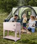 80 Quart Rolling Cooler Cart Portable Bar Drink Cooler On Wheels With Ice Chest Shelf Bottle Opener And Cap Catch For Patio Parties BBQ Beach Activities Pink in campsite setting