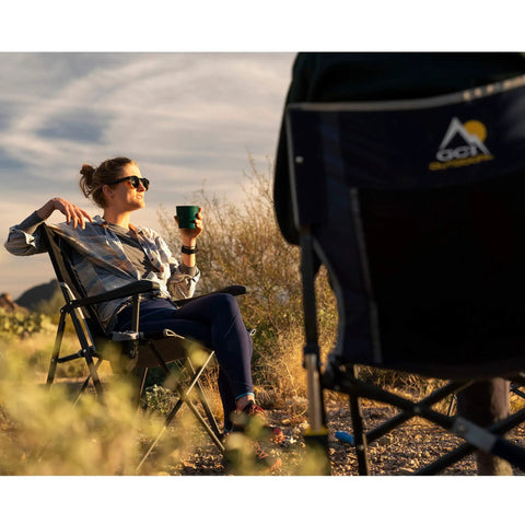 Woman relaxing in Ultra Easy Fold Up Outdoor Camping Chair For Adults With Mesh Back And Wide Seat Sturdy Powder Coated Steel Frame.