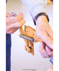 Close-up of hands holding Complete Three Piece Spring Repair Kit For Goldenrod Model 400 Fence Stretcher Splicer during installation
