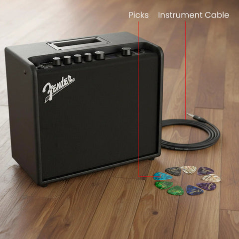 Mustang LT25 Guitar Combo Amp Bundle with Cable and Picks on wooden floor, showcasing Fender amp, cable, and 12-pack picks.