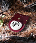 Dual Grit Axe Sharpener Stone 400 1000 with leather sheath in forest setting