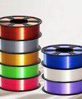 Multiple spools of colorful Silk PLA Filament 1.75mm for 3D printer including metallic white with glossy silk finish.