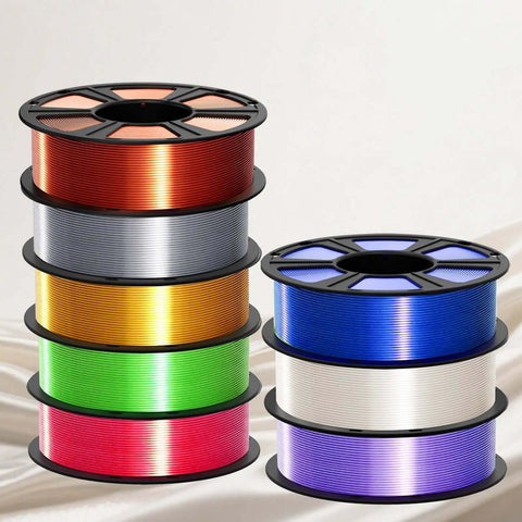 Multiple spools of colorful Silk PLA Filament 1.75mm for 3D printer including metallic white with glossy silk finish.