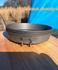 Ultralight Titanium Frying Pan 165mm D6.5 for camping with stacked Toaks plates on wood surface outdoors