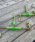 4 Pack 5/16 To 3/8 Inch Heavy Duty Hi Vis Green Ratchet Tie Down With Grab Hook And Slip Clip 5400 Lb Working Load Limit on wooden surface.