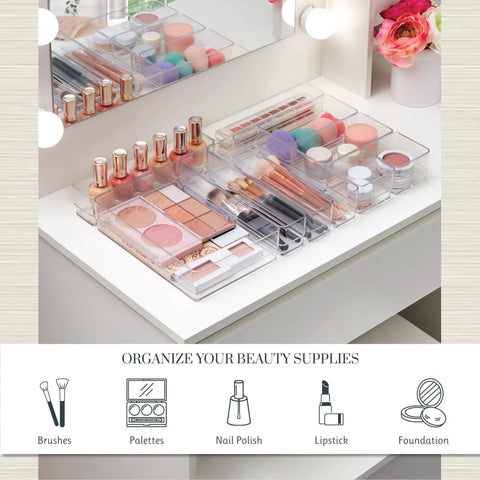 SimpleSort 10 Piece Stackable Clear Drawer Organizer Set with Multi Size Trays for Makeup Vanity and Office Desk Storage BPA Free American Made Clear Plastic Dividers That Keep Your Gear Neat, Accessible, and Ready to Grab displayed on a vanity table holding makeup items like brushes and palettes.