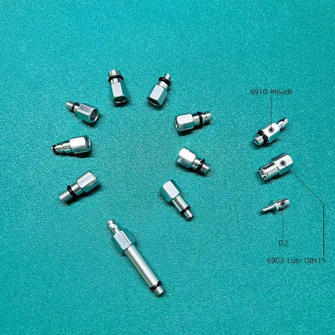 All In One Hydraulic Brake Bleed Connector Kit For Bicycles, 13 Piece Pro Grade Aluminum Alloy Set arranged on green background