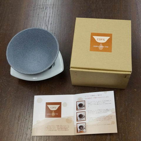 Premium Japanese Ceramic Coffee Filter Reusable Pour Over Dripper With Rock Solid Brown Holder next to packaging and instructions.