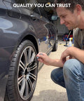 Man using Premium Wheel Touchup Paint For Bmw Jet Black Alloy Rims on a rim to repair scratches.