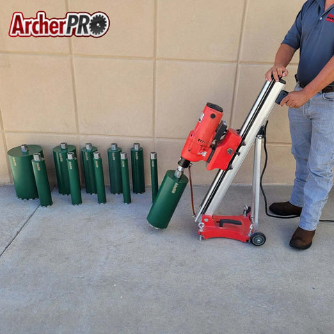 Archer PRO 2-1/4-in aggressive diamond turbo core drill bits with V-tip; red core drill stand; operator near green bits.