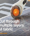 45mm Rotary Cutter Replacement Blades 5 Pack Ultra Sharp Precision Knives cutting through fabric layers on a ruler.