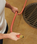 Man holding Heavy Duty Three Quarter Inch By Seventy Five Foot Garden Hose With Kink-Resistant, Commercial Grade Rubber And Vinyl Construction